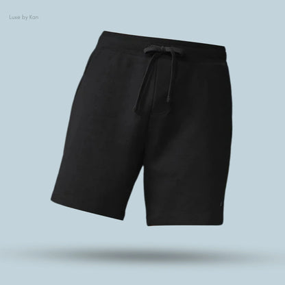 Alo Chill Short in Black, flat lay on light blue background