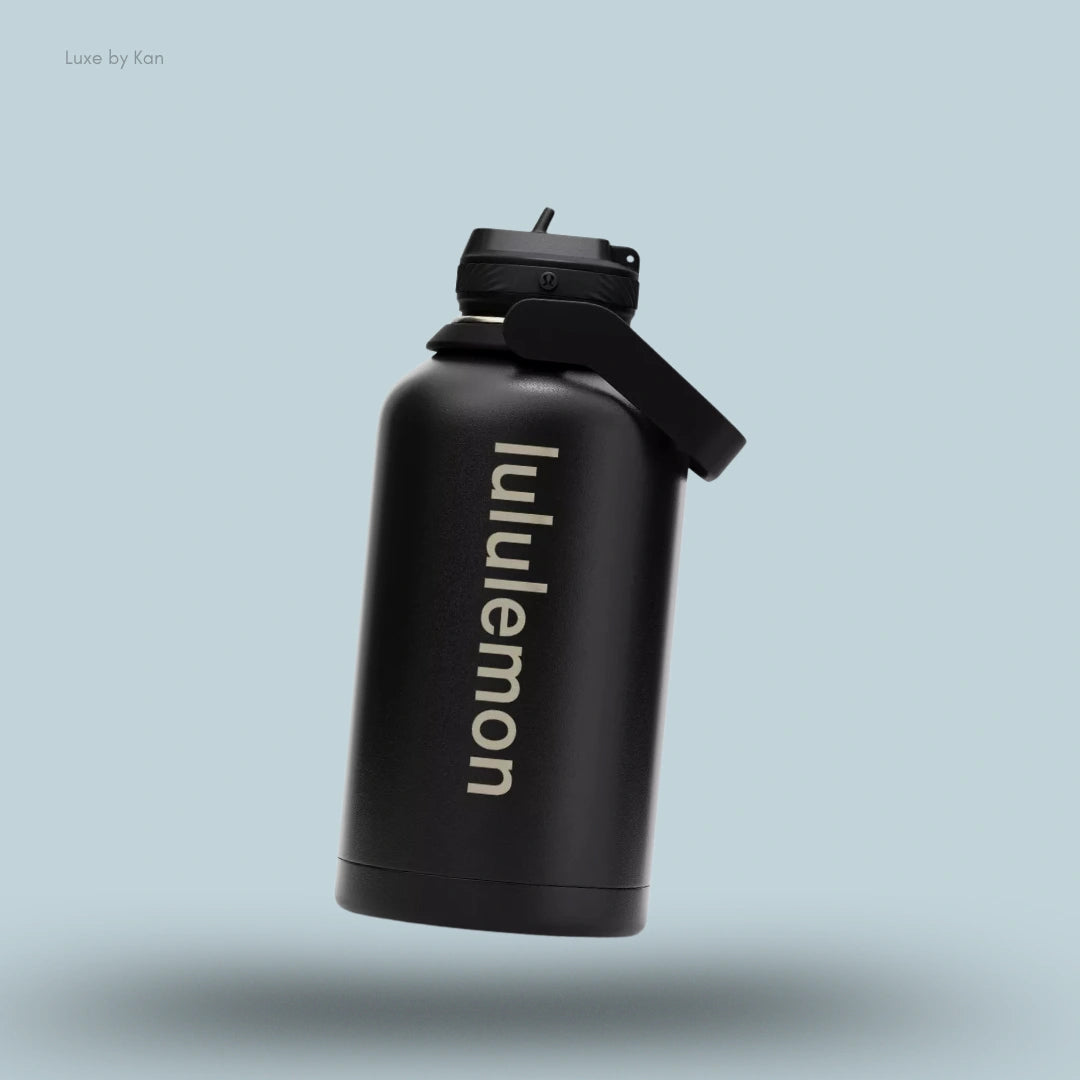 Lululemon Back to Life Sport Bottle 64oz in Black, flat lay on light blue background