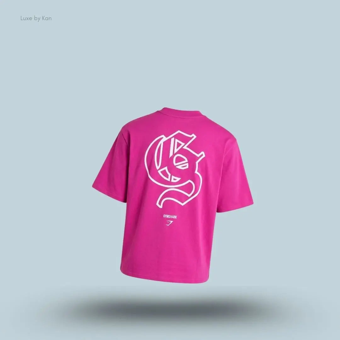Gymshark Performance T-Shirt in pink shade displayed on a blue background with an oversized boxy-fit short-sleeve design back view