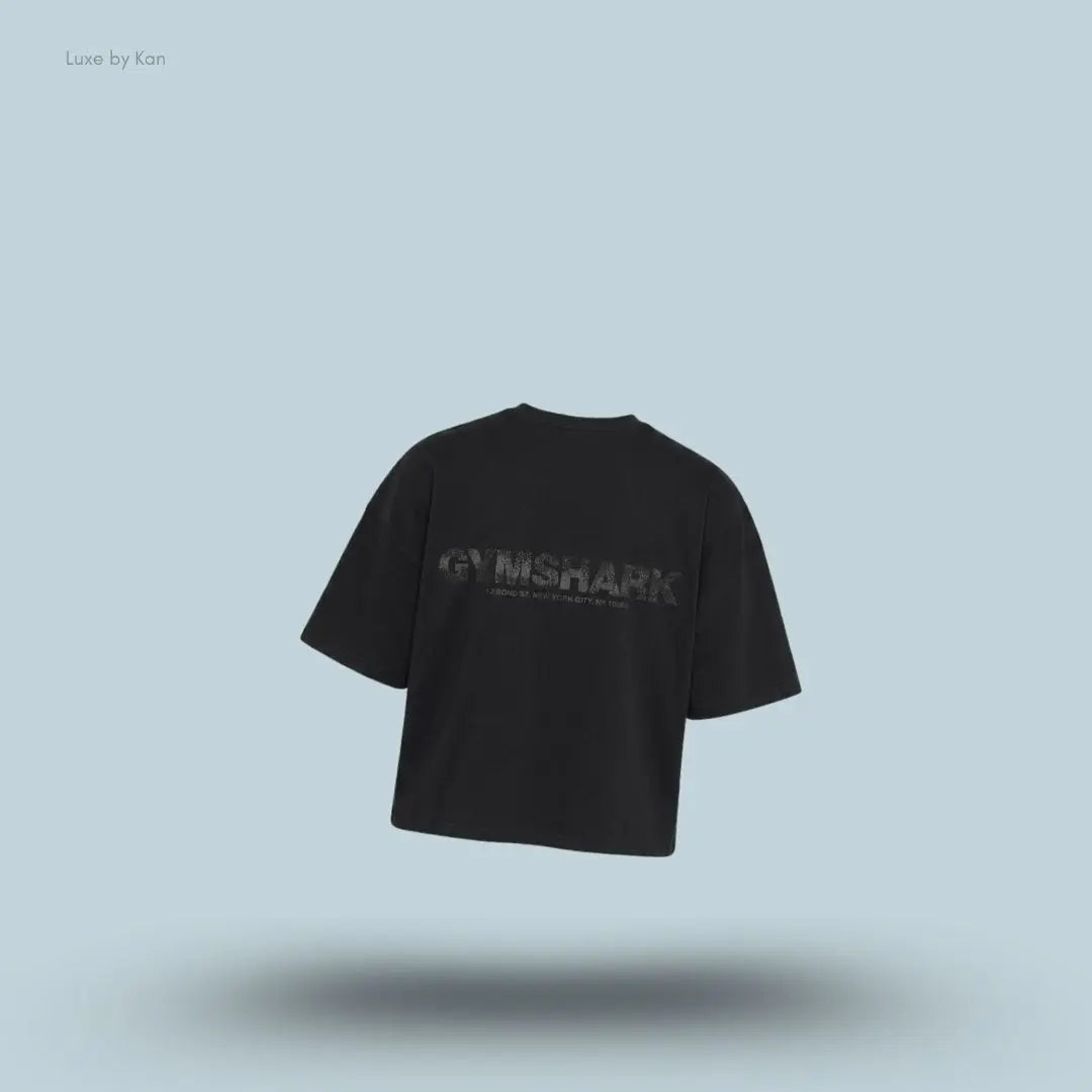 Gymshark Accent Boxy T-Shirt in black displayed on a blue background with an oversized boxy short-sleeve design back view.
