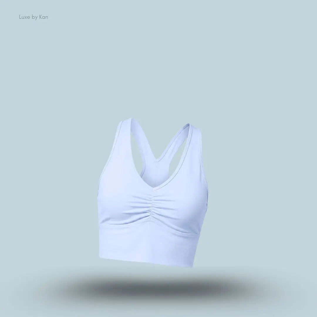 Alo Wild Thing Bra in Light Provence Blue, flat lay on light blue background