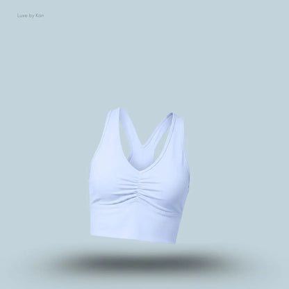 Alo Wild Thing Bra in Light Provence Blue, flat lay on light blue background