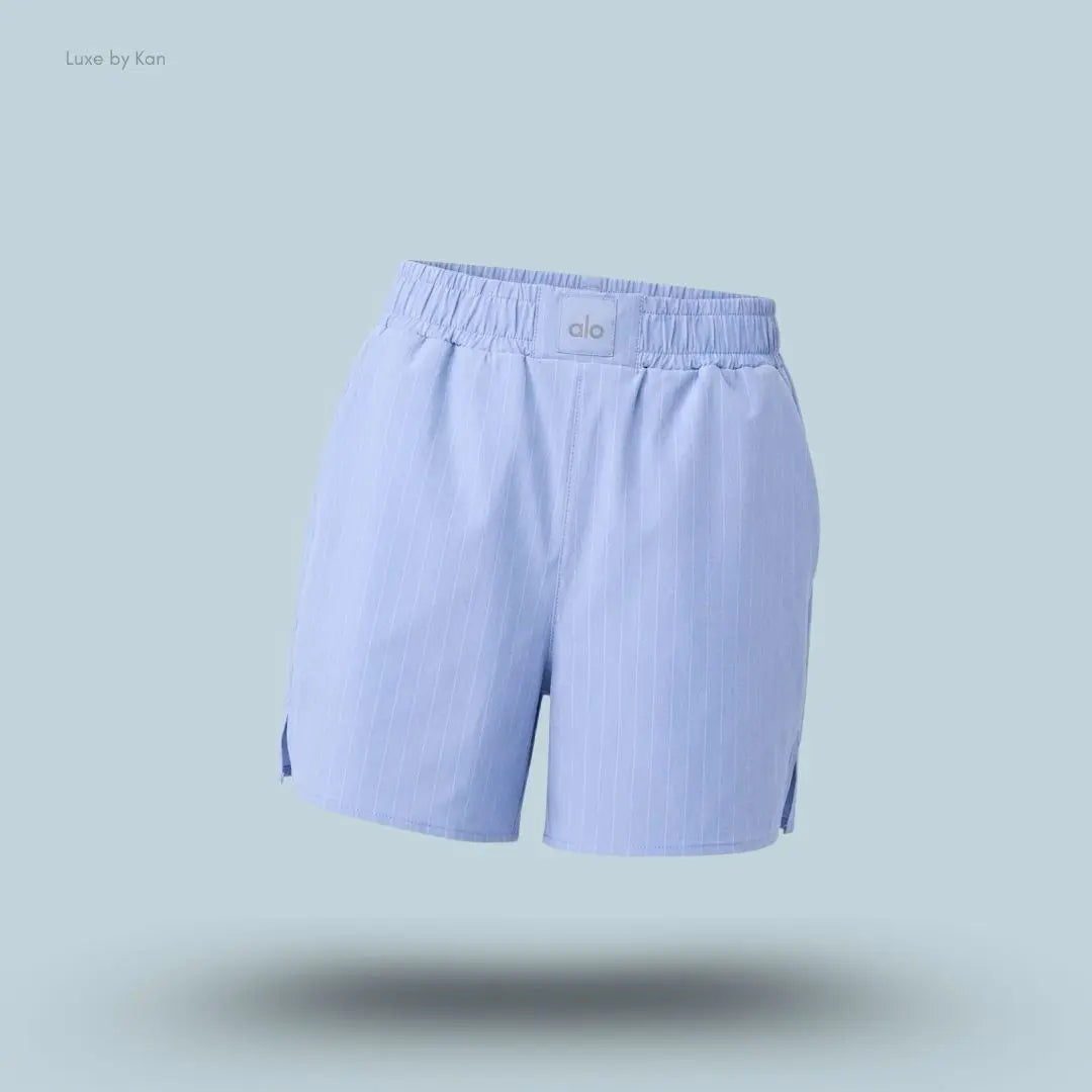 Alo Pinstripe Daylight Boxer Short in Light Provence Blue/White, flat lay on light blue background