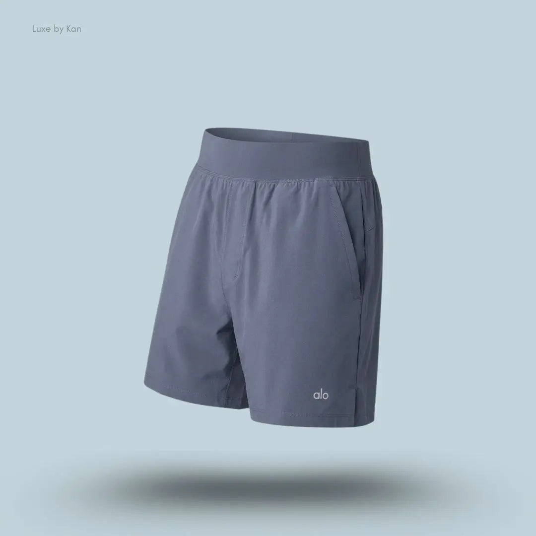 Alo 5 inch Repetition Short in Bluestone, flat lay on light blue background