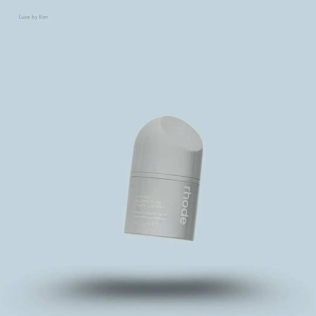 Rhode Peptide Glazing Fluid in an opaque gray container with the brand name in white on the side.