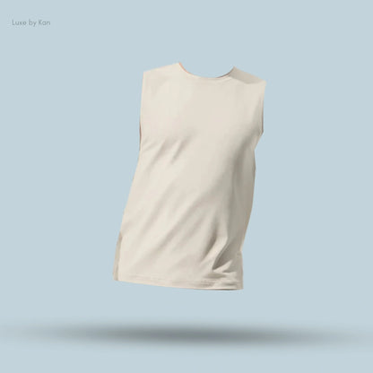 Alo Conquer Muscle Tank in Bone, flat lay on light blue background