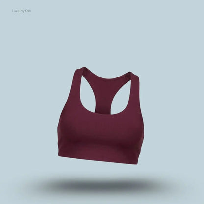 Alo Airlift Advantage Racerback Bra in burgundy, flat lay on light blue background