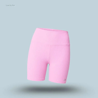 Alo 5 inch Seamless Ribbed Favorite Short in Candy Heart Pink, flat lay on light blue background