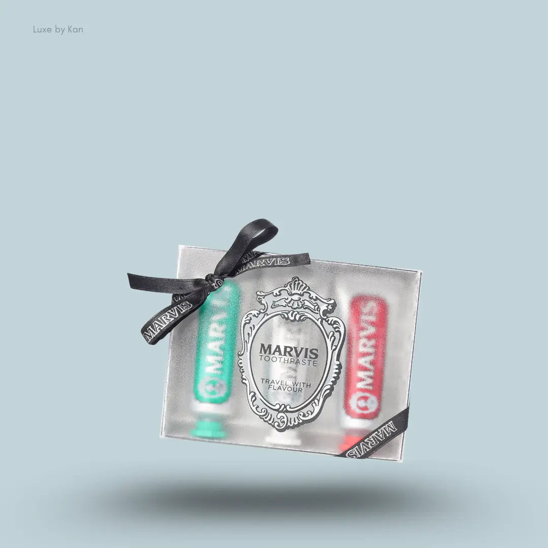 Marvis Travel Flavour Toothpaste Trio three toothpaste tubes in packaging on blue background