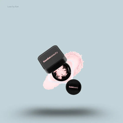 Huda Beauty Baby Bake Easy Bake Loose Powder Mini in Cherry Blossom, on light blue background