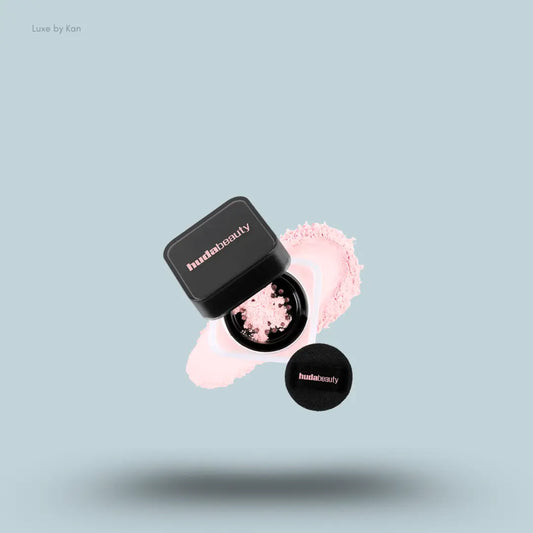 Huda Beauty Baby Bake Easy Bake Loose Powder Mini in Cherry Blossom, on light blue background