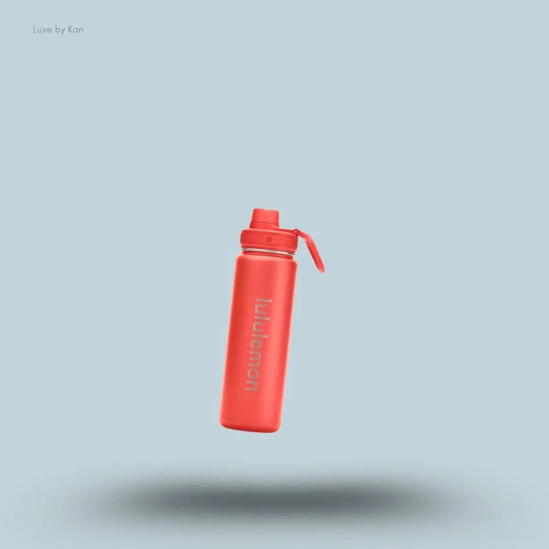 Lululemon Back to Life Sport Bottle 24oz in Cherry Ember, flat lay on light blue background