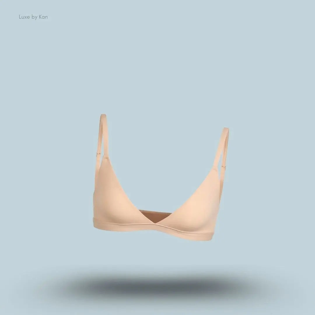 Skims Fits Everybody Triangle Bralette in nude, front view on a light blue background with a floating product display.