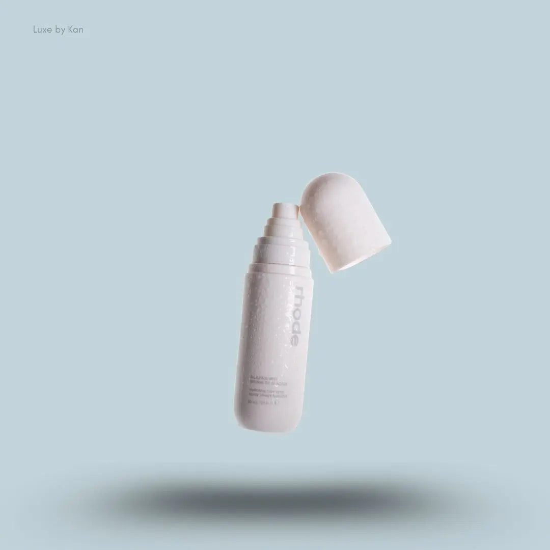 Rhode Glazing Mist in a cream, capsule-shaped bottle, featuring product details in black font.