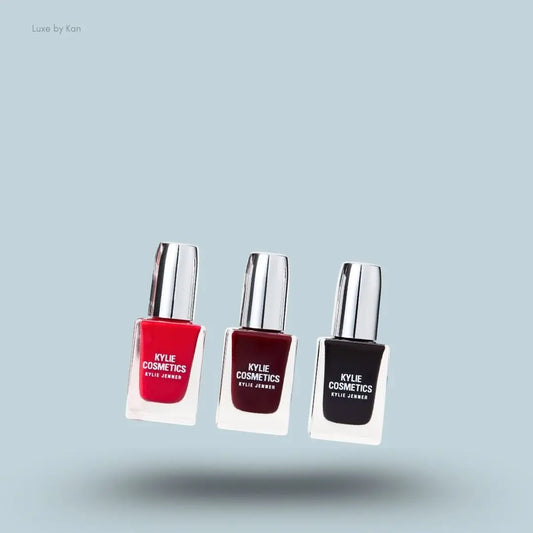 Kylie Cosmetics Holiday Collection Nail Lacquer Trio bottles and swatch on blue background — LBK