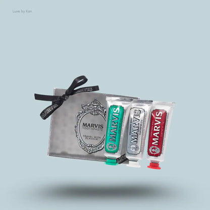 Marvis Travel Flavour Toothpaste Trio three toothpaste tubes with packaging on blue background