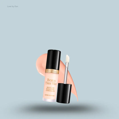 Too Faced Born This Way Super Coverage Concealer in Cream Puff, on a light blue background