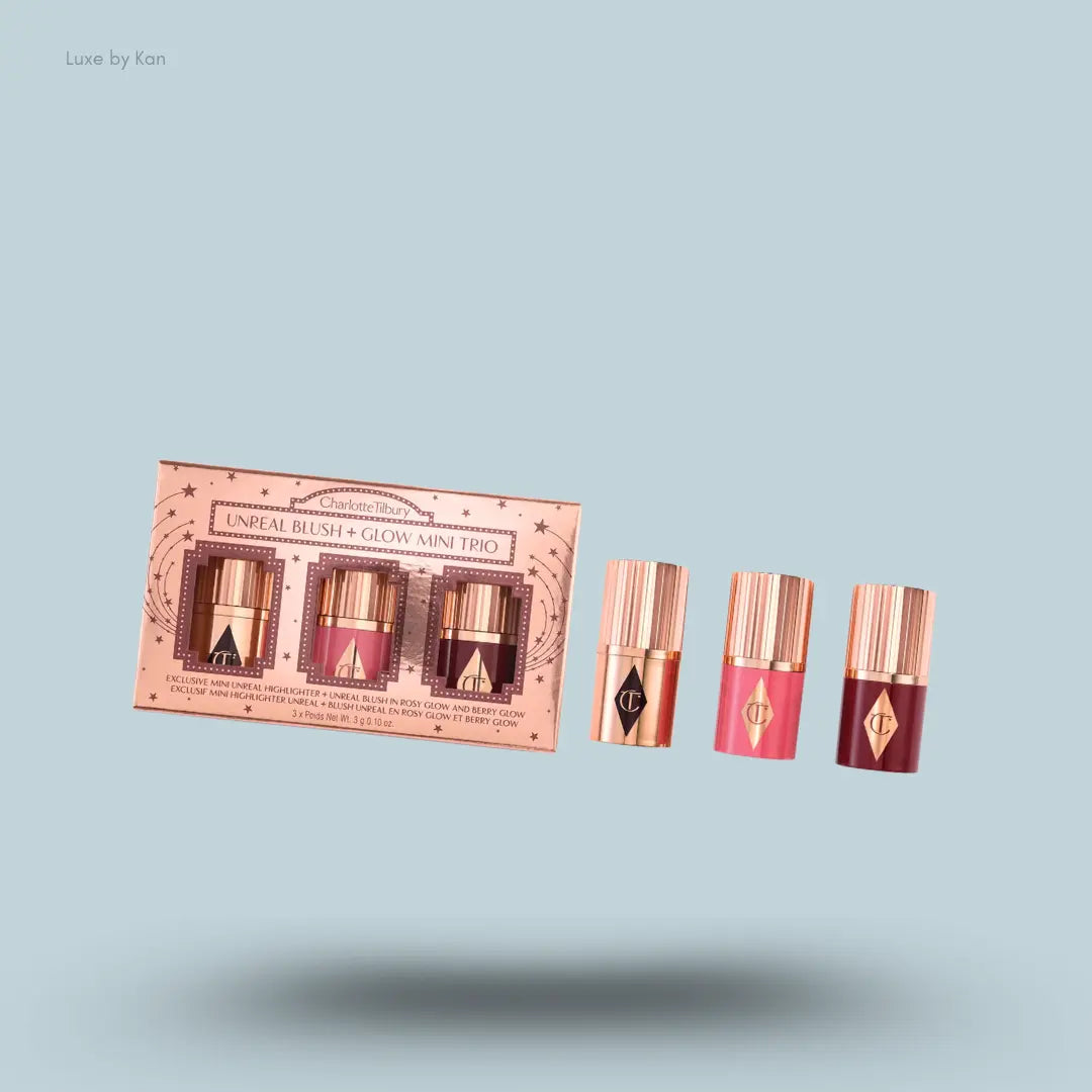 Charlotte Tilbury Unreal Blush + Glow Mini Trio – three products with packaging on blue background