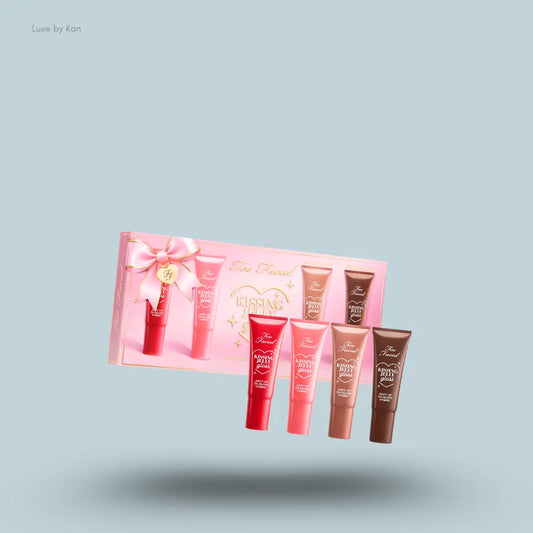 Too Faced Kissing Jelly Set four lip gloss tubes with packaging on blue background