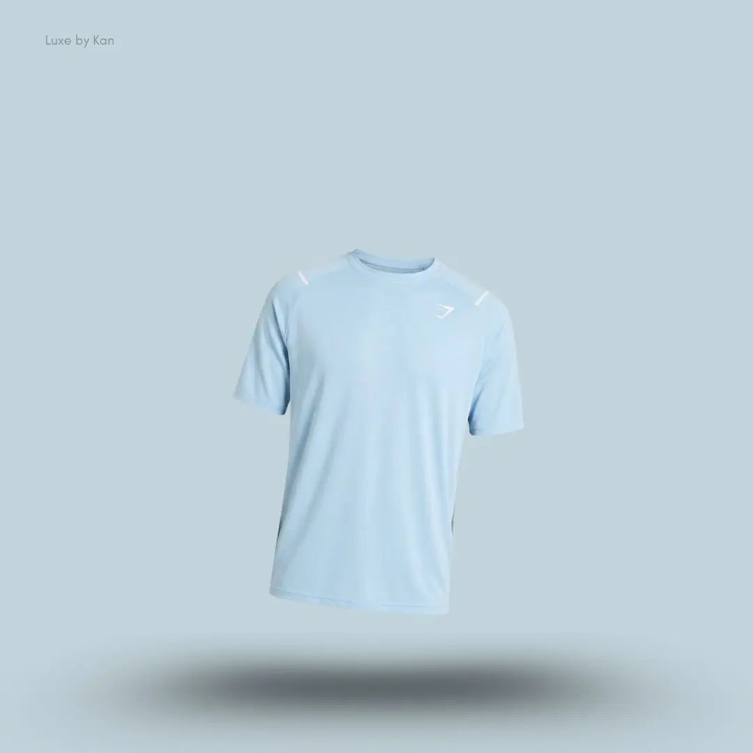 Gymshark Arrival Contrast T-Shirt in light blue displayed on a blue background with contrast shoulder piping and short sleeves