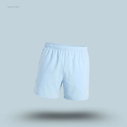 Gymshark Arrival Contrast Shorts in light blue displayed on a blue background with a slim-fit athletic shorts design
