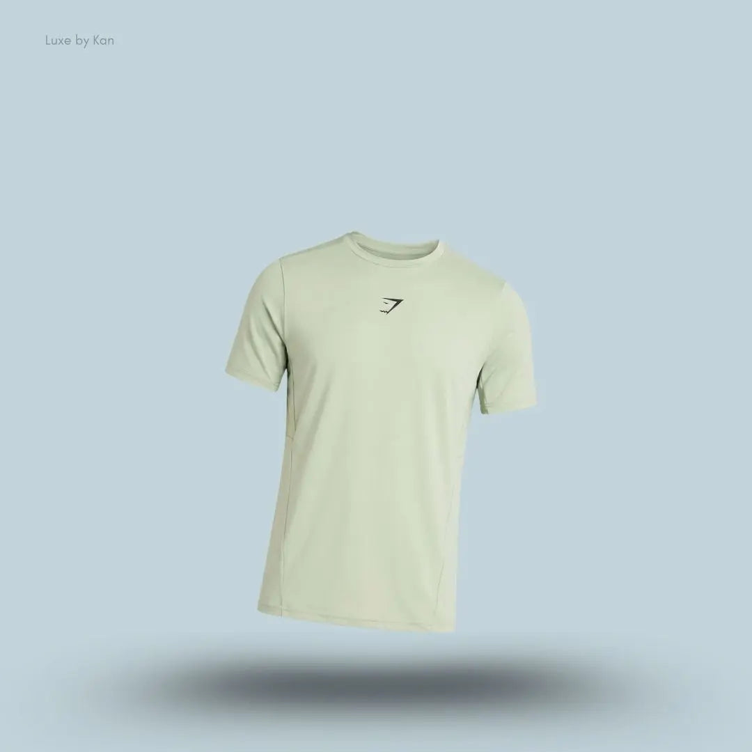 gymshark Sport T-Shirt in green with short sleeves and front logo, men's slim-fit performance training tee on blue background.