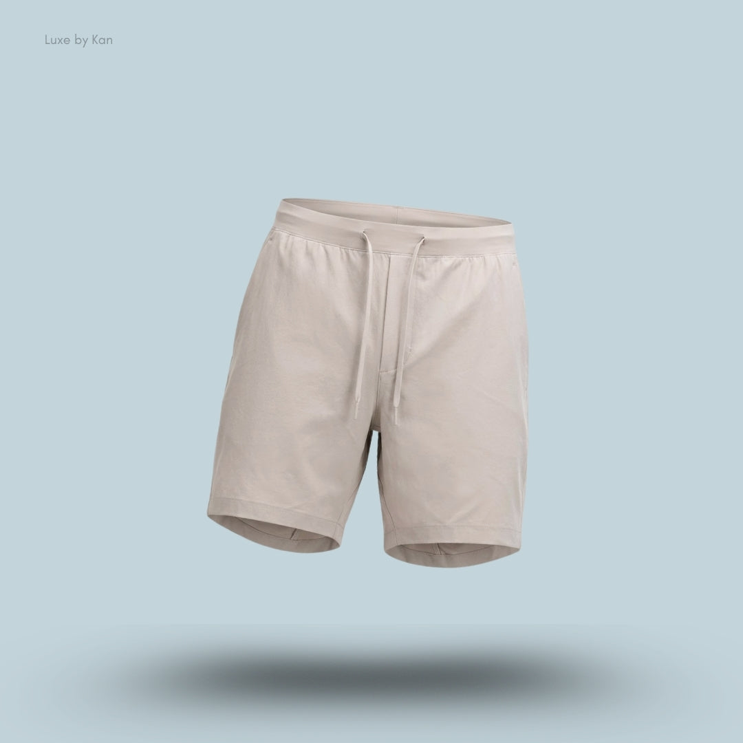 Lululemon Zeroed In Linerless Short 7 inch in Downtown Tan, flat lay on light blue background