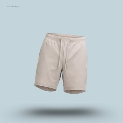 Lululemon Zeroed In Linerless Short 7 inch in Downtown Tan, flat lay on light blue background