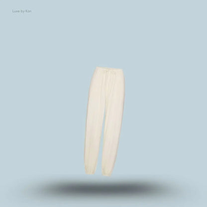 SKIMS Sleep Balloon Pant in Ecru, flat lay on light blue background