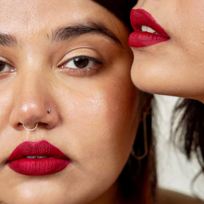 Close-up of a woman's lips, highlighting her simp lipstick shade and smooth skin, with a hint of glossy shine.