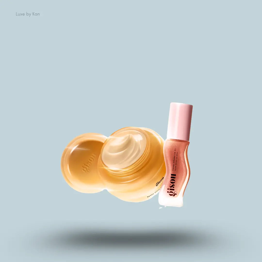 Gisou Mini Gloss Duo with honey hair mask and Glazed Plum lip oil on a blue background
