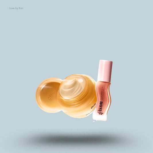 Gisou Mini Gloss Duo with honey hair mask and Glazed Plum lip oil on a blue background