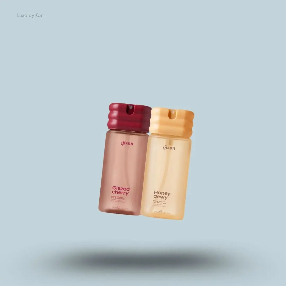 Gisou Honey Infused Hair & Body Mist Duo in Honey Dewy and Glazed Cherry, flat lay on light blue background
