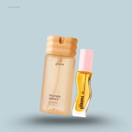 Gisou Honey Glow Spritz & Swipe Duo with Honey Dewy mist and Honey Gold lip oil on a blue background