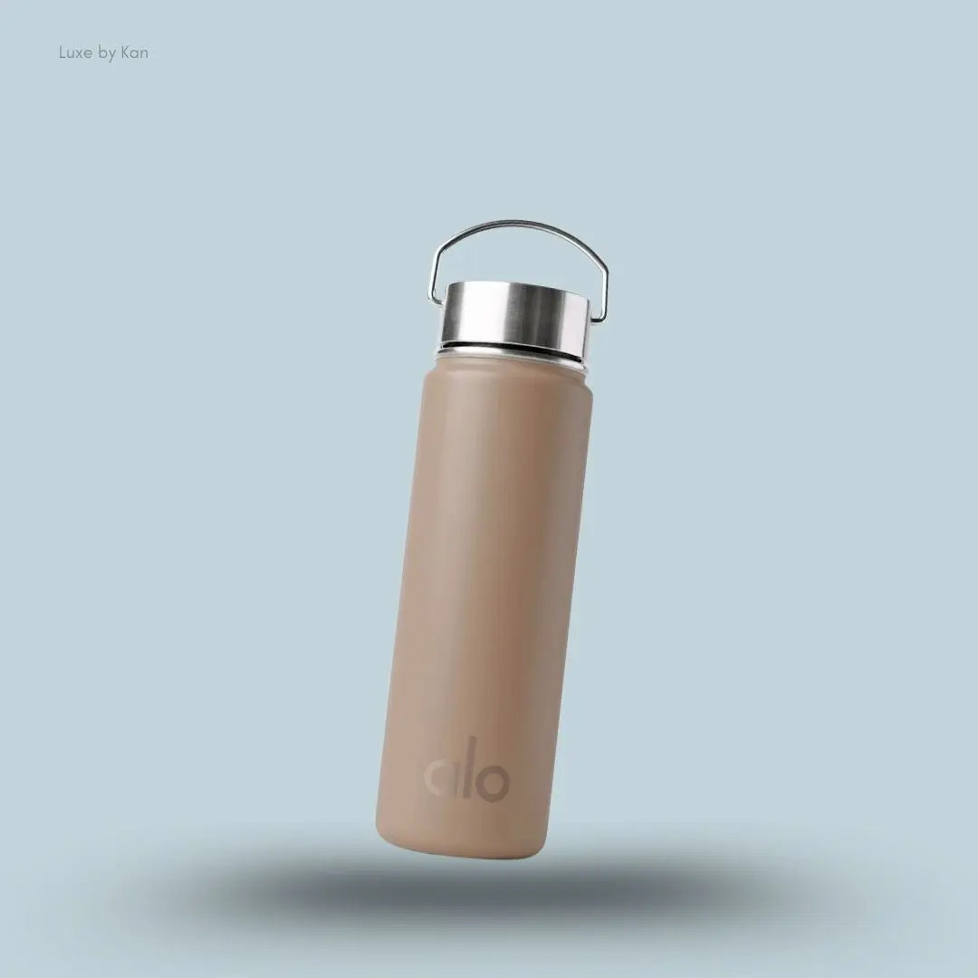 Alo Water Bottle in Gravel, flat lay on light blue background