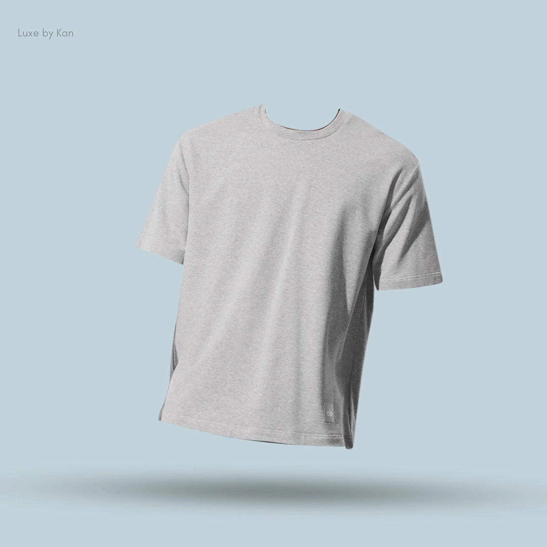 Alo Double Take Short Sleeve in Athletic Heather Grey, flat lay on light blue background