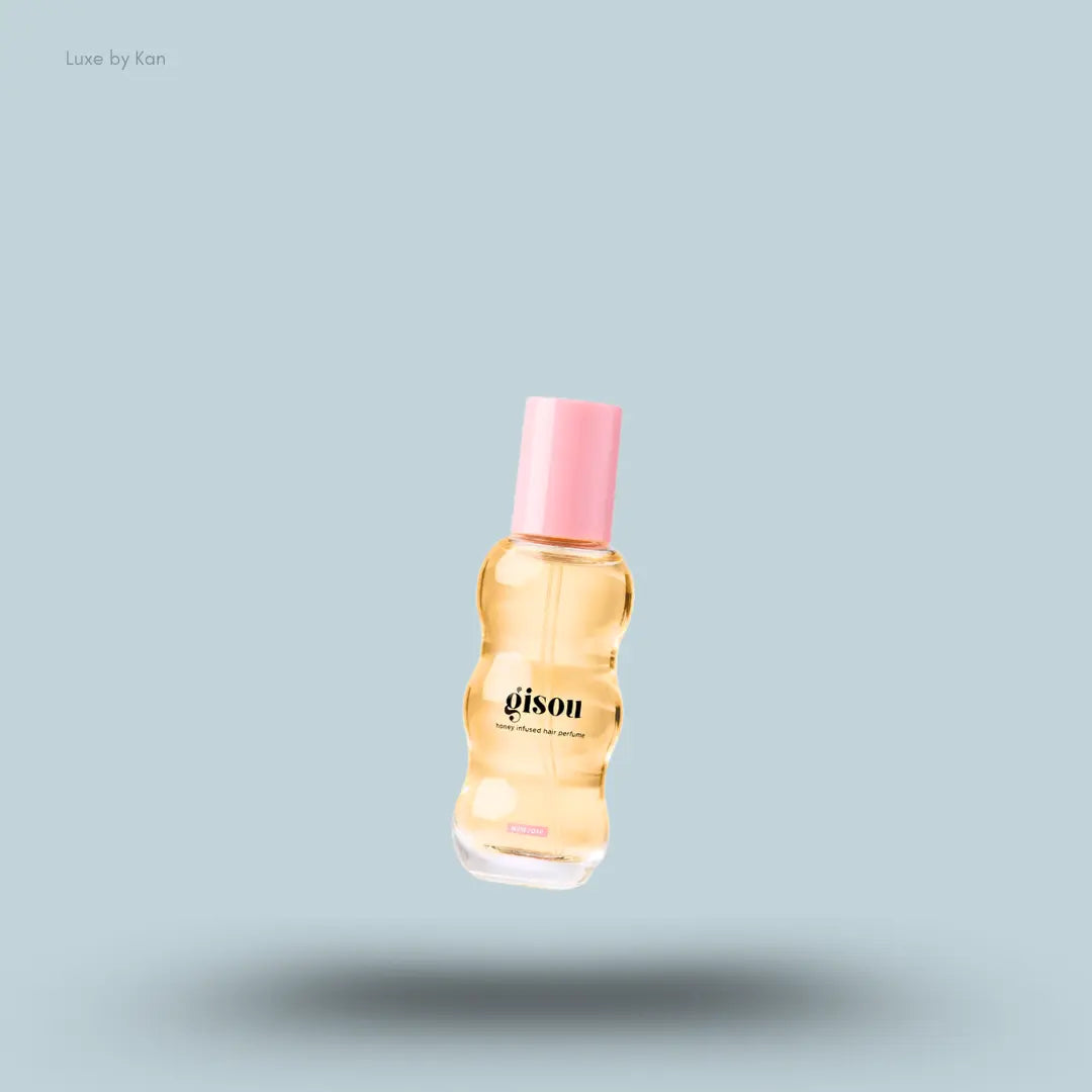 Gisou Vanilla Rose Duo Wild Rose honey hair perfume bottle on a blue background
