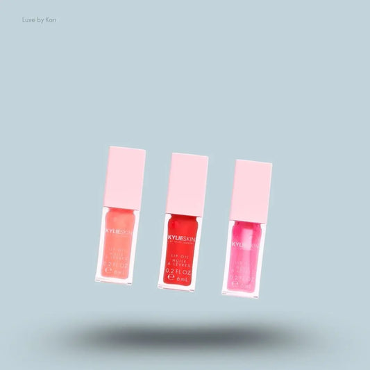 Kylie Cosmetics Lip Oil Set bottles on blue background — Luxe by Kan India