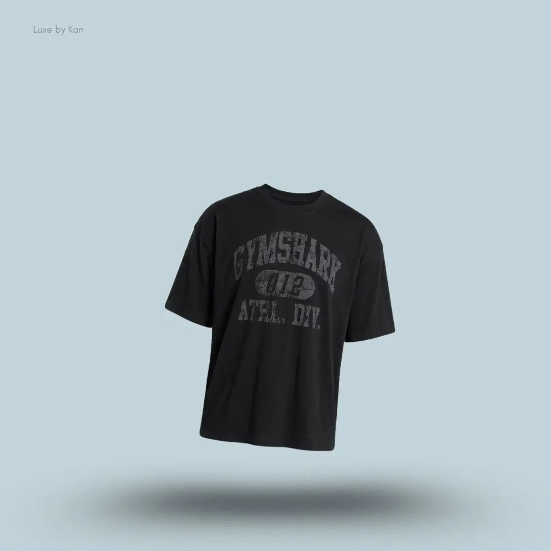Gymshark Athletic Division Graphic T-Shirt in black with front graphic print on a blue background