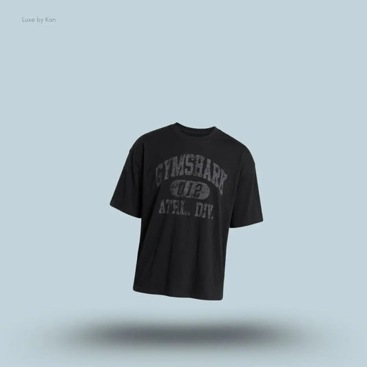 Gymshark Athletic Division Graphic T-Shirt in black with front graphic print on a blue background
