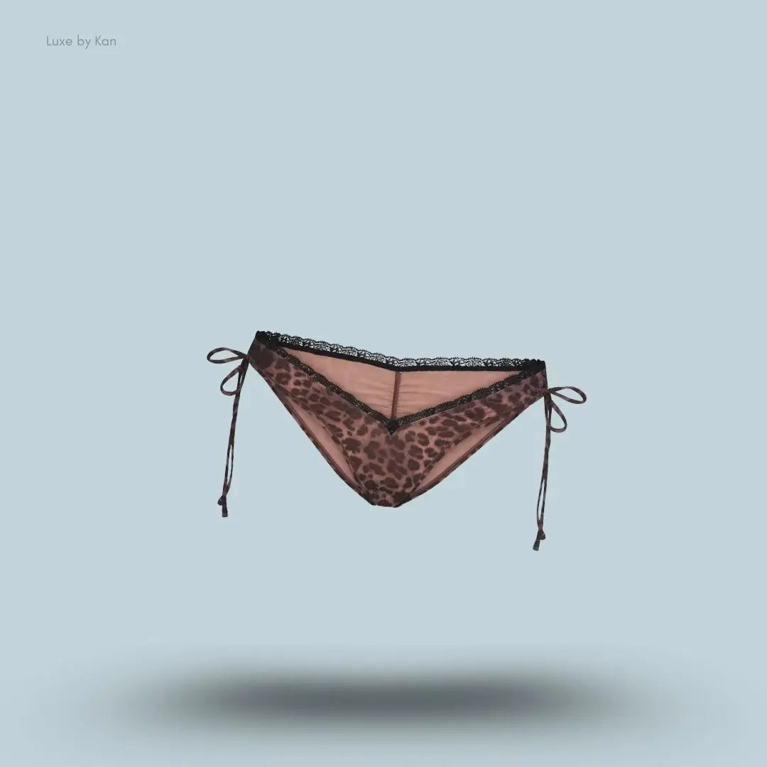 SKIMS Fits Everybody Lace Micro Tanga in Umber Leopard Print, flat lay on light blue background