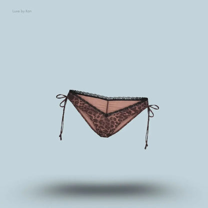 SKIMS Fits Everybody Lace Micro Tanga in Umber Leopard Print, flat lay on light blue background