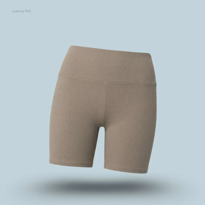 Alo 5 inch Seamless Ribbed Favorite Short in Light Cocoa, flat lay on light blue background