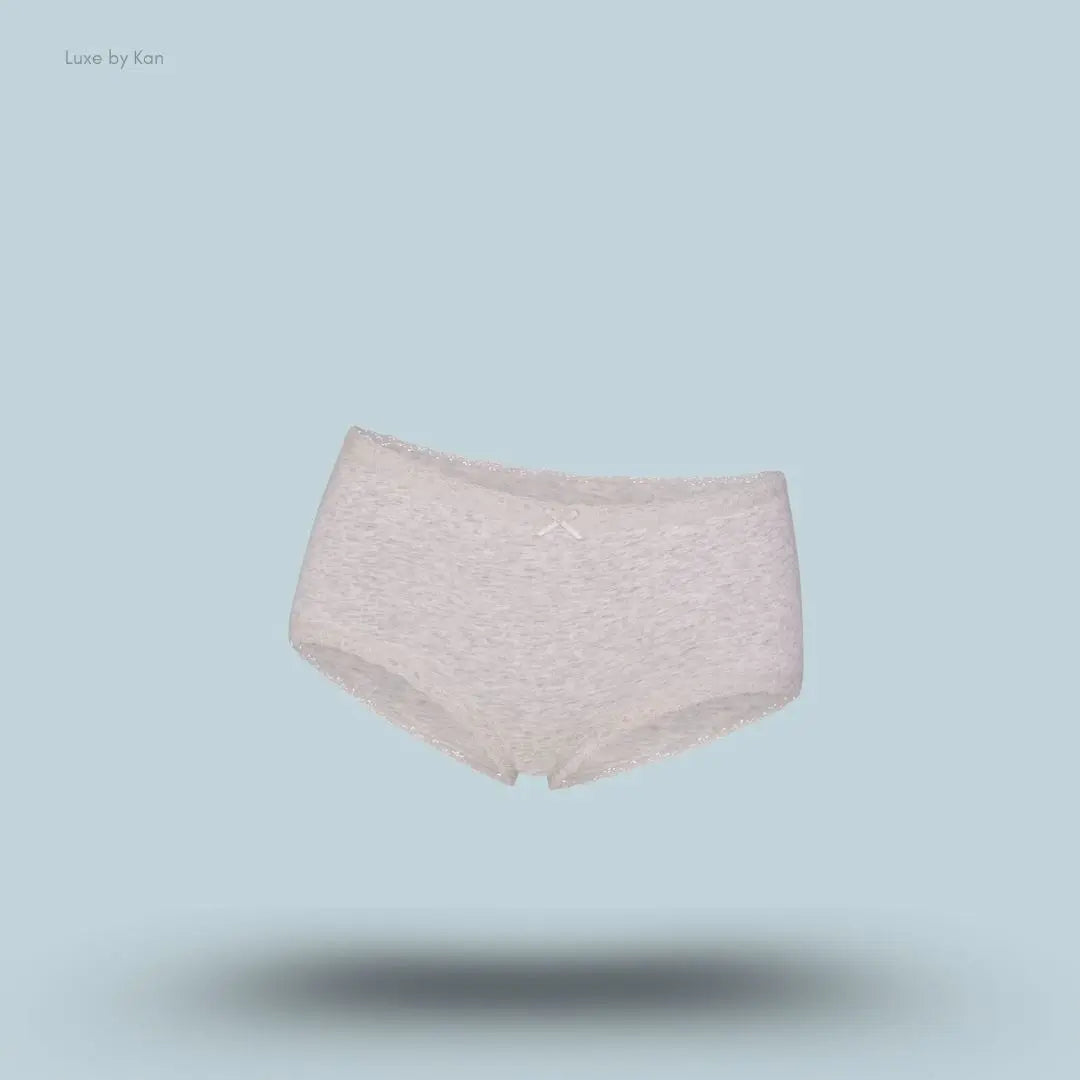 SKIMS Lightweight Cotton Lace Boy Short in Light Heather Grey, flat lay on light blue background