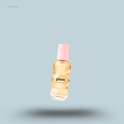 Gisou Vanilla Rose Duo honey infused lip oil bottle on a blue background