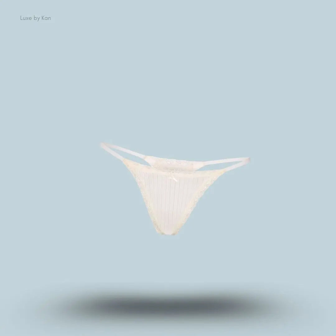 SKIMS Lightweight Cotton Pointelle Lace String Thong in Marble Tonal, flat lay on light blue background