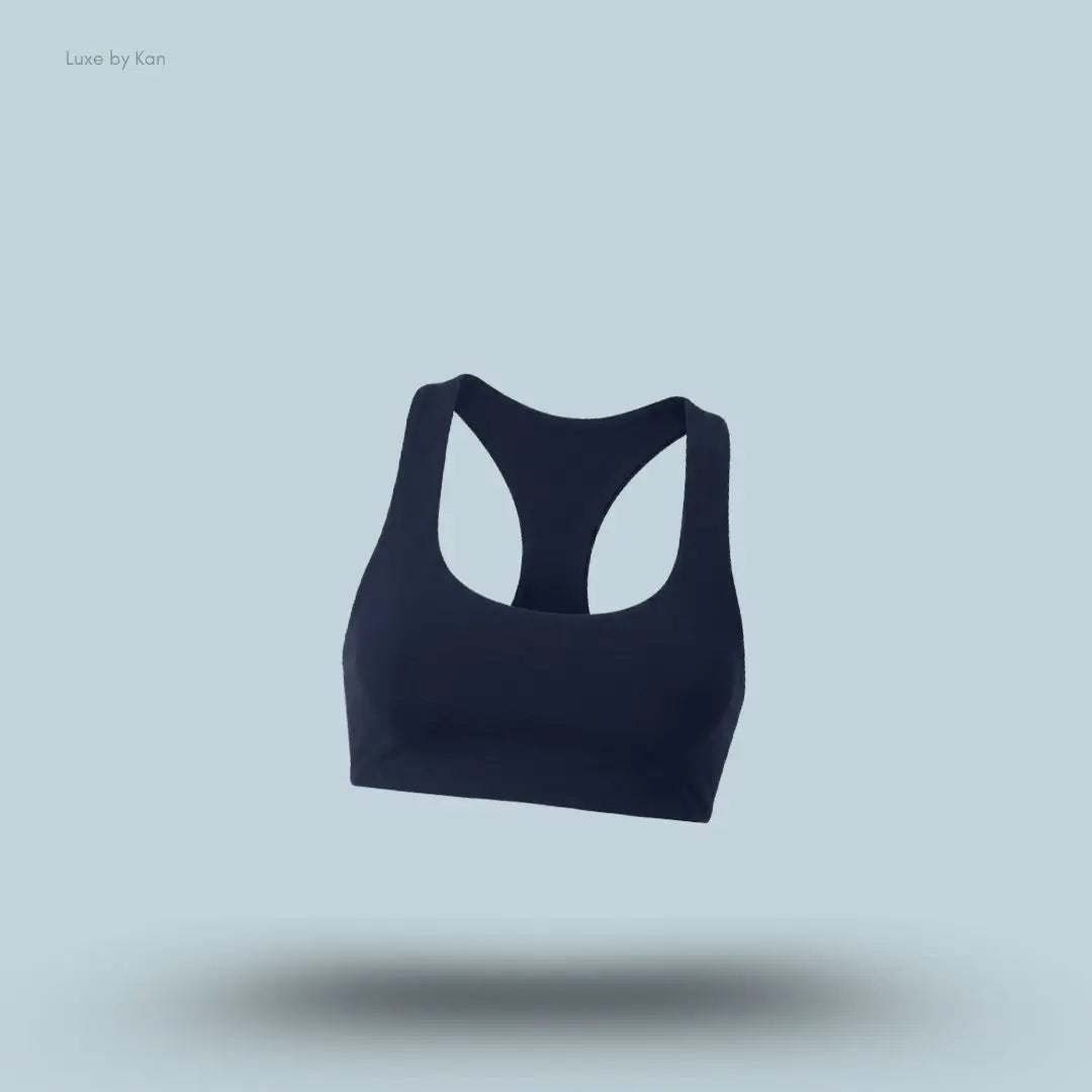 Alo Airlift Advantage Racerback Bra in navy, flat lay on light blue background