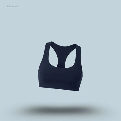 Alo Airlift Advantage Racerback Bra in navy, flat lay on light blue background