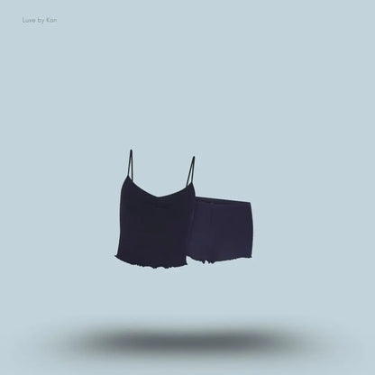 SKIMS Sleep Cami Set in Navy, flat lay on light blue background