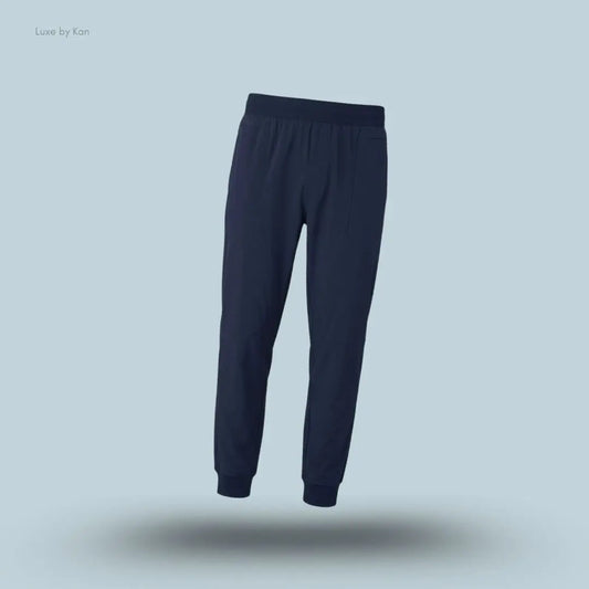Alo Co-Op Pant in Navy, flat lay on light blue background
